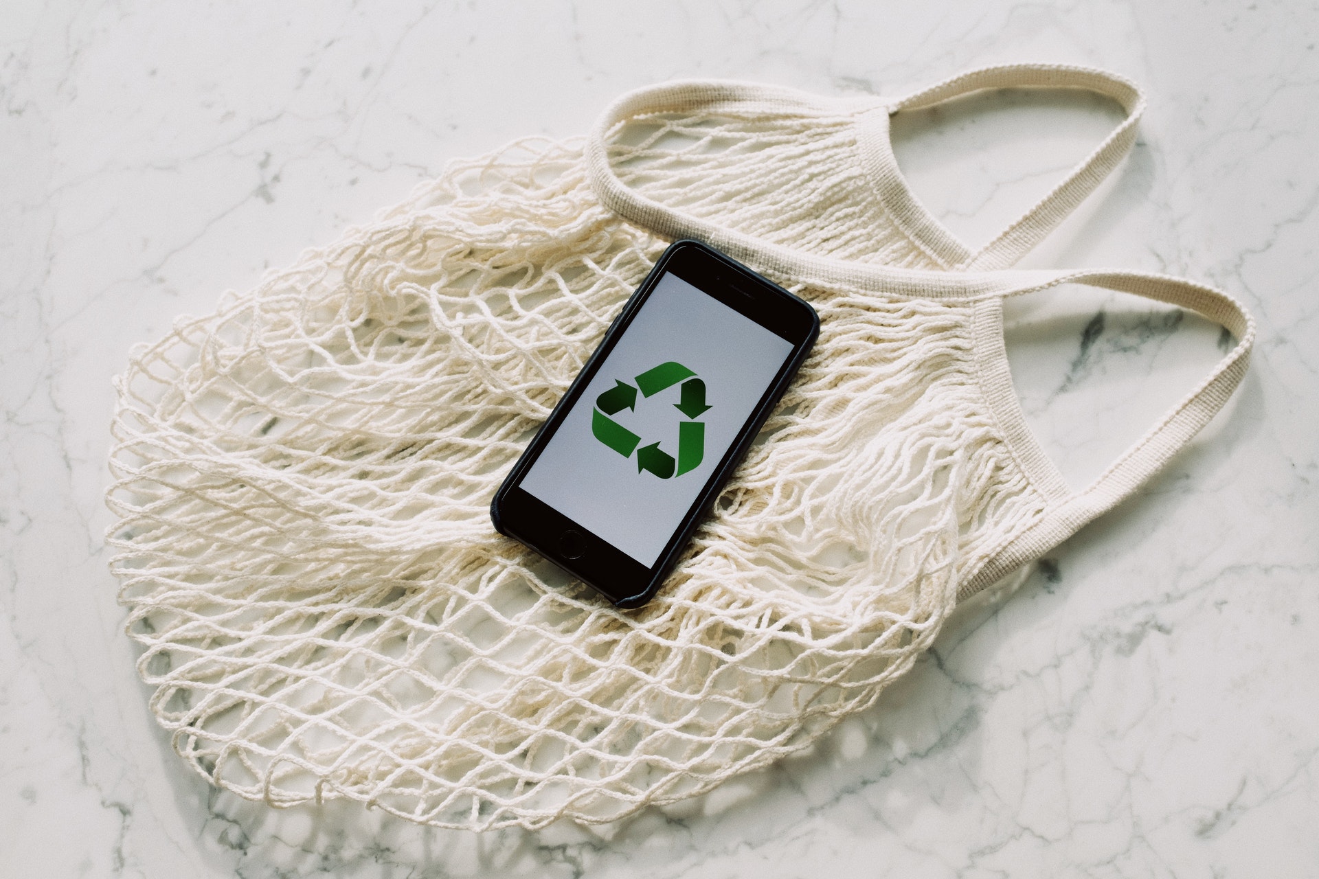 reusable bag and phone with recycling symbol
